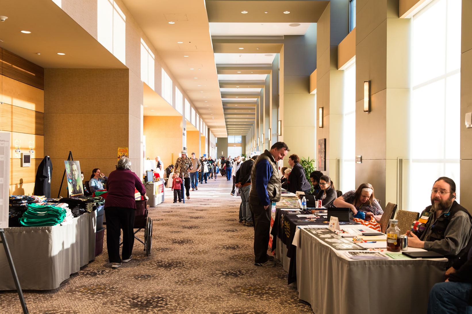 Picture of the hallway outside of dealers with people talking and walking